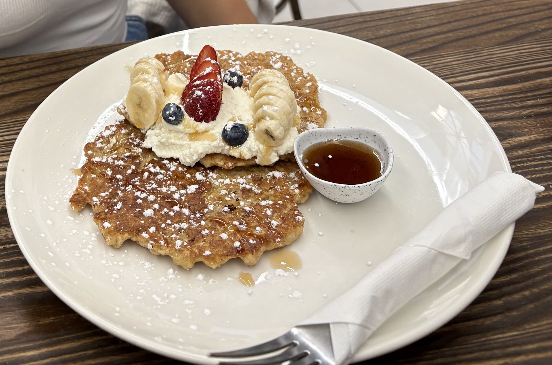 Protein pancakes with fruit, ricotta, and syrup